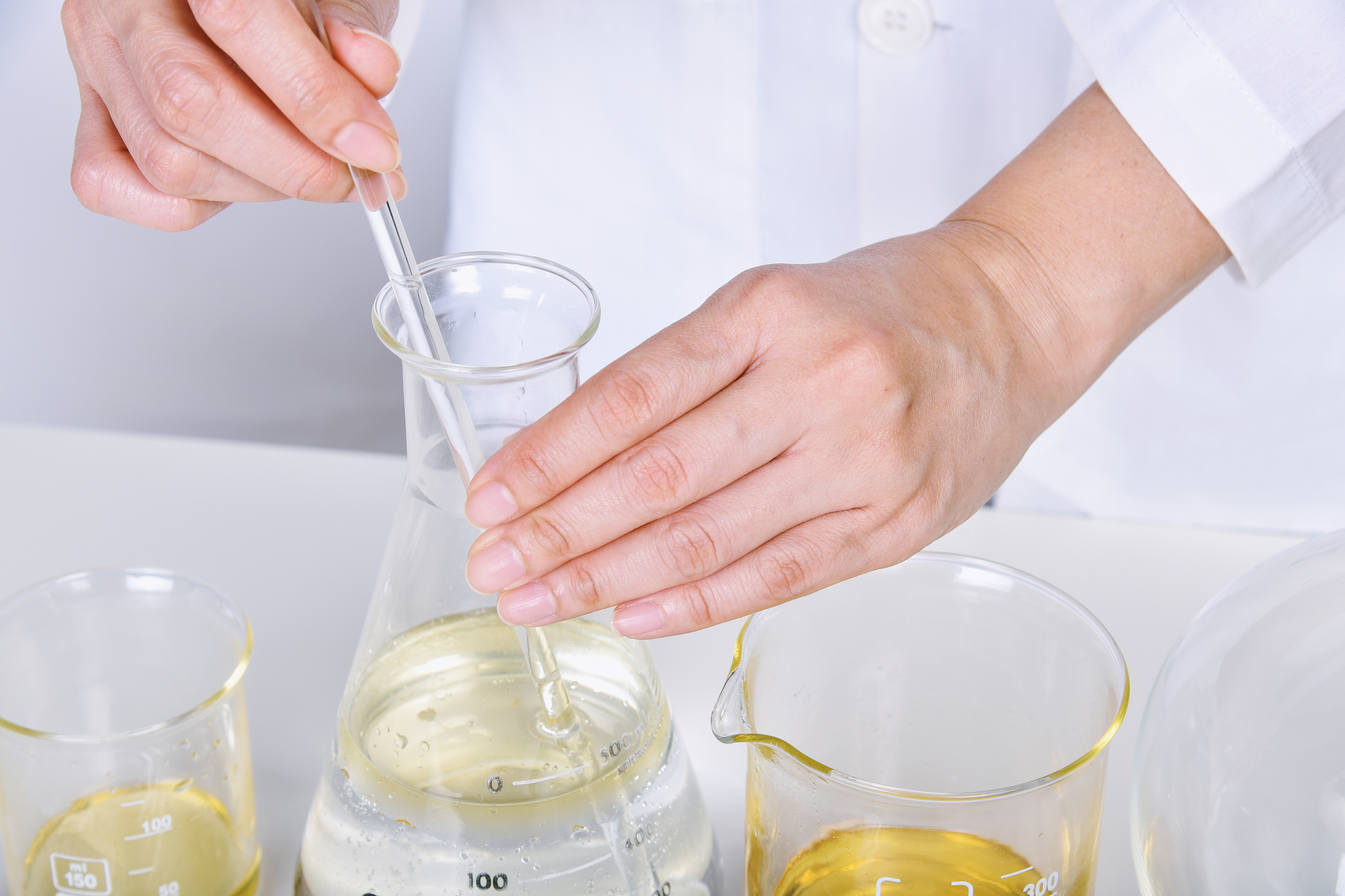 Chemical reagent pouring and mixing, Laboratory and science experiments, Formulating the chemical for medical research.